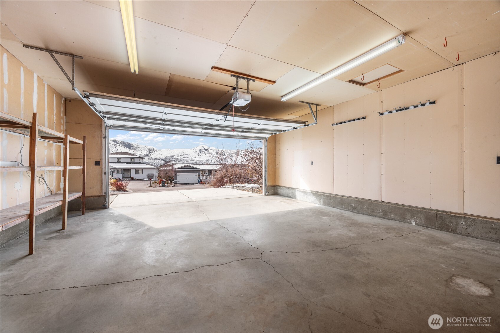 Oversized 2 car garage with door to patio in fenced back yard.