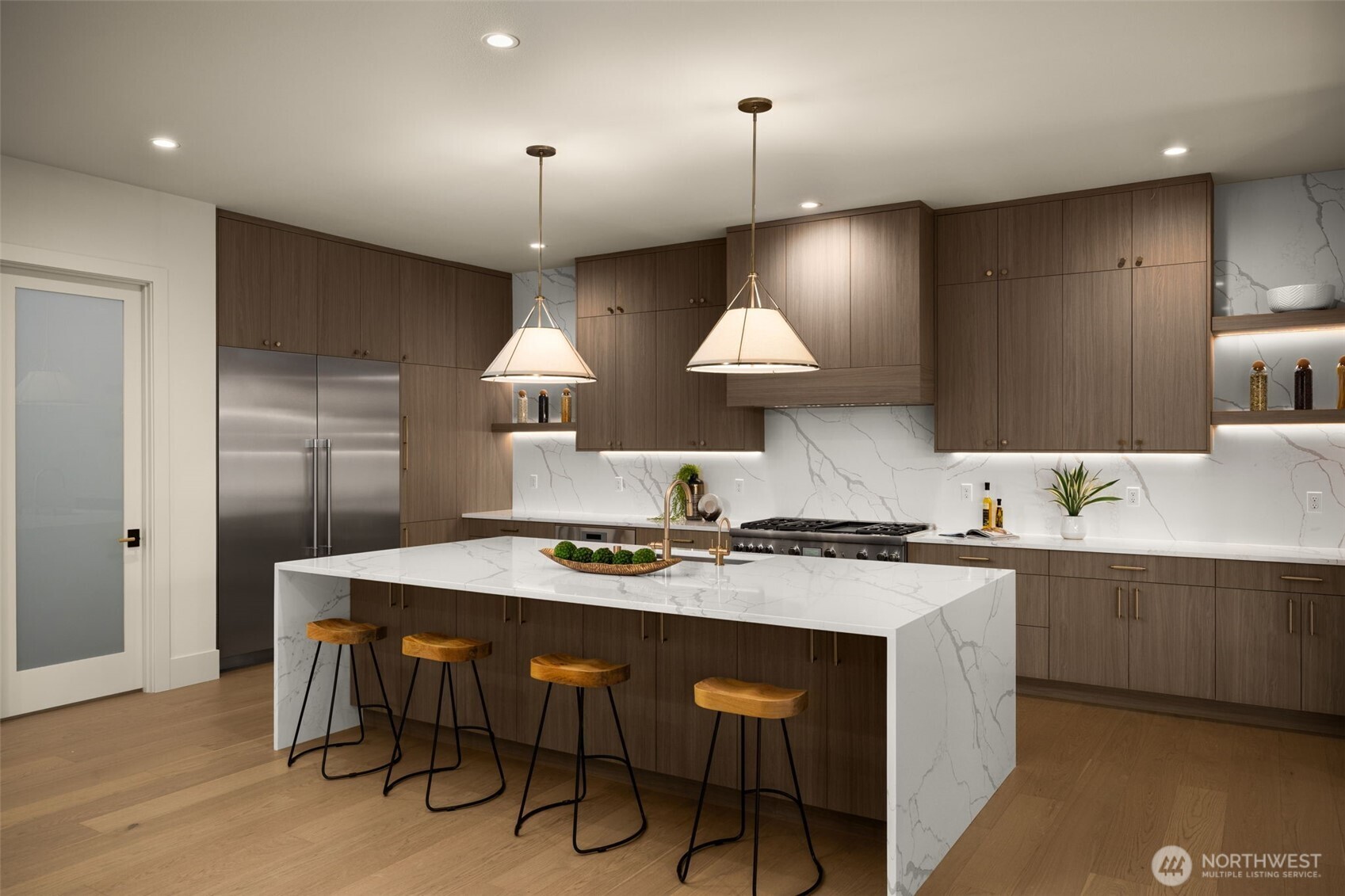 Chef's kitchen with Bellmont custom cabinetry and waterfall countertop