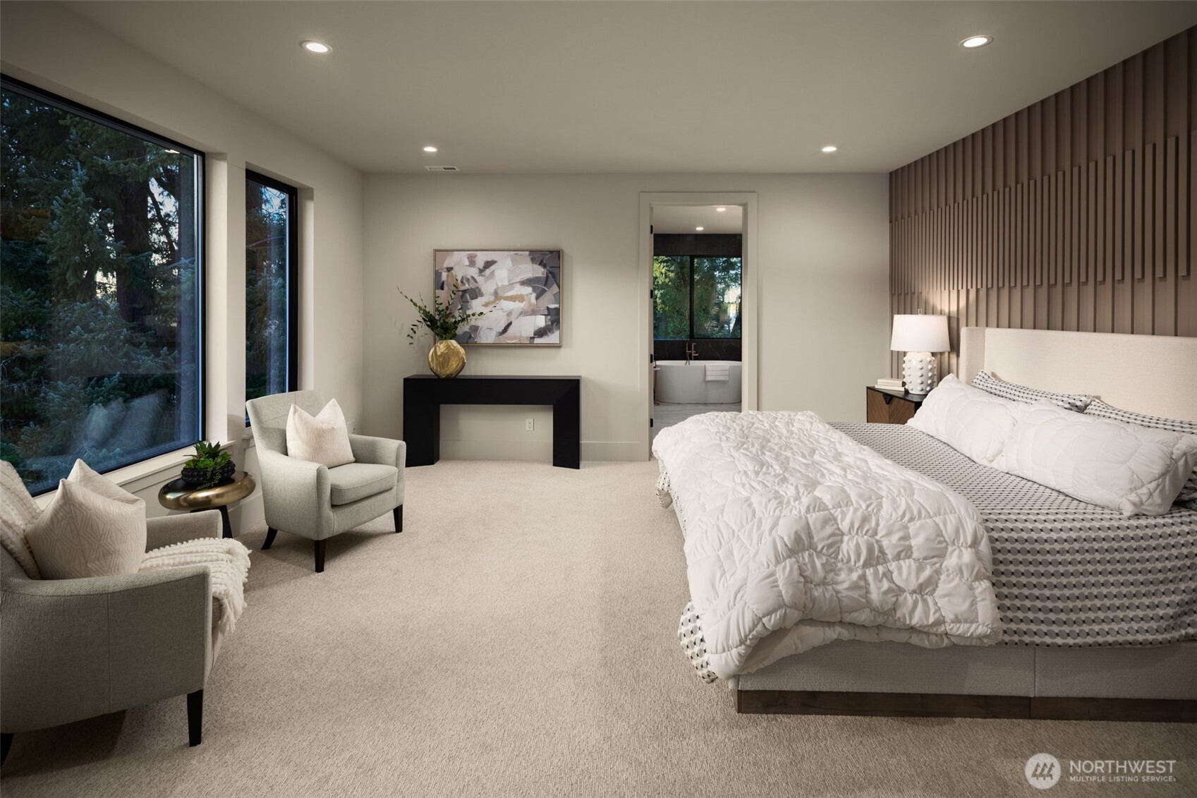 Large primary suite with custom accent wall