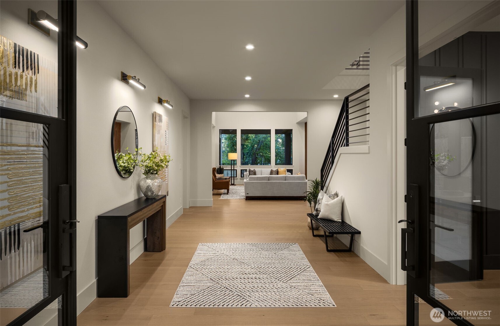 Commanding entryway with double iron and glass doors