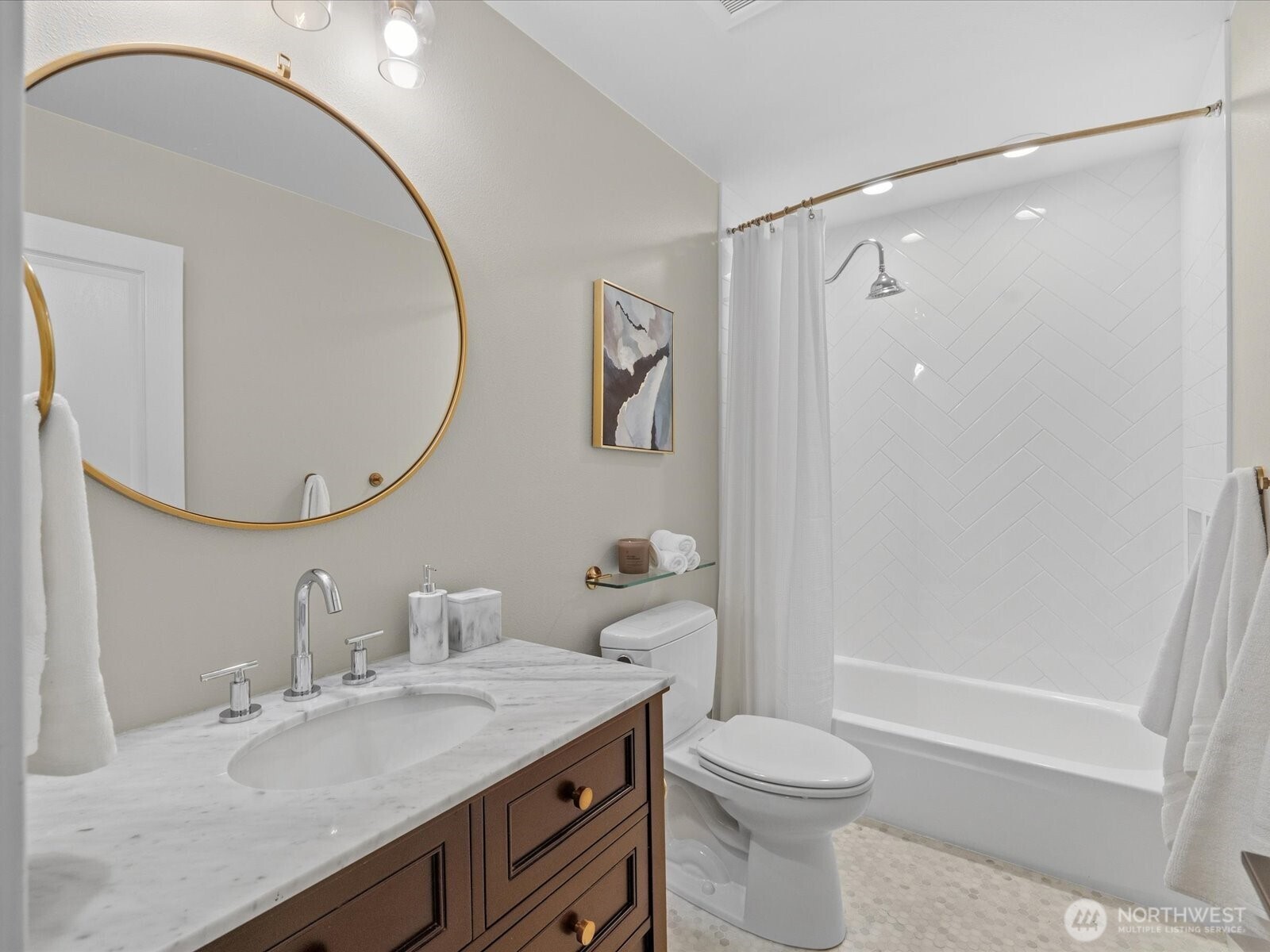 Bathroom with single vanity, stone countertop, and tub with tile surround