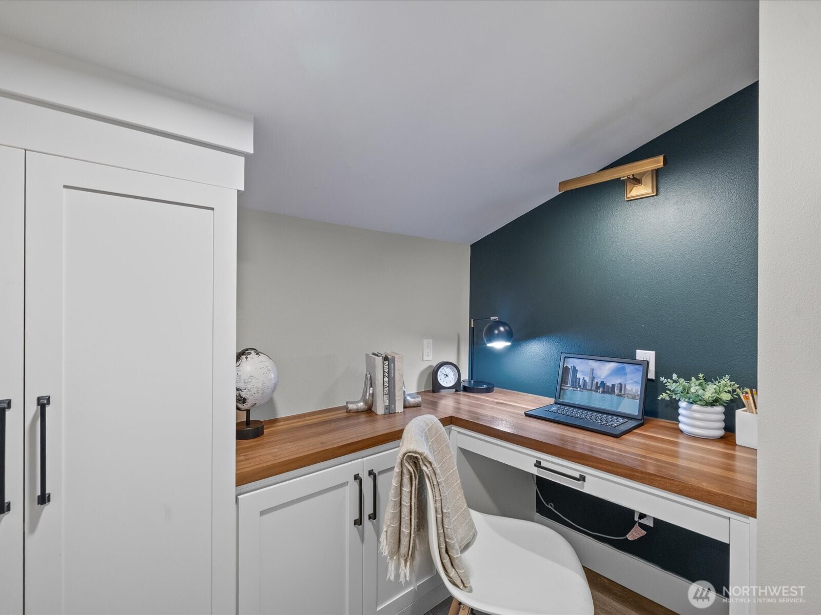 Built-in office nook with desk, cabinetry, and workspace