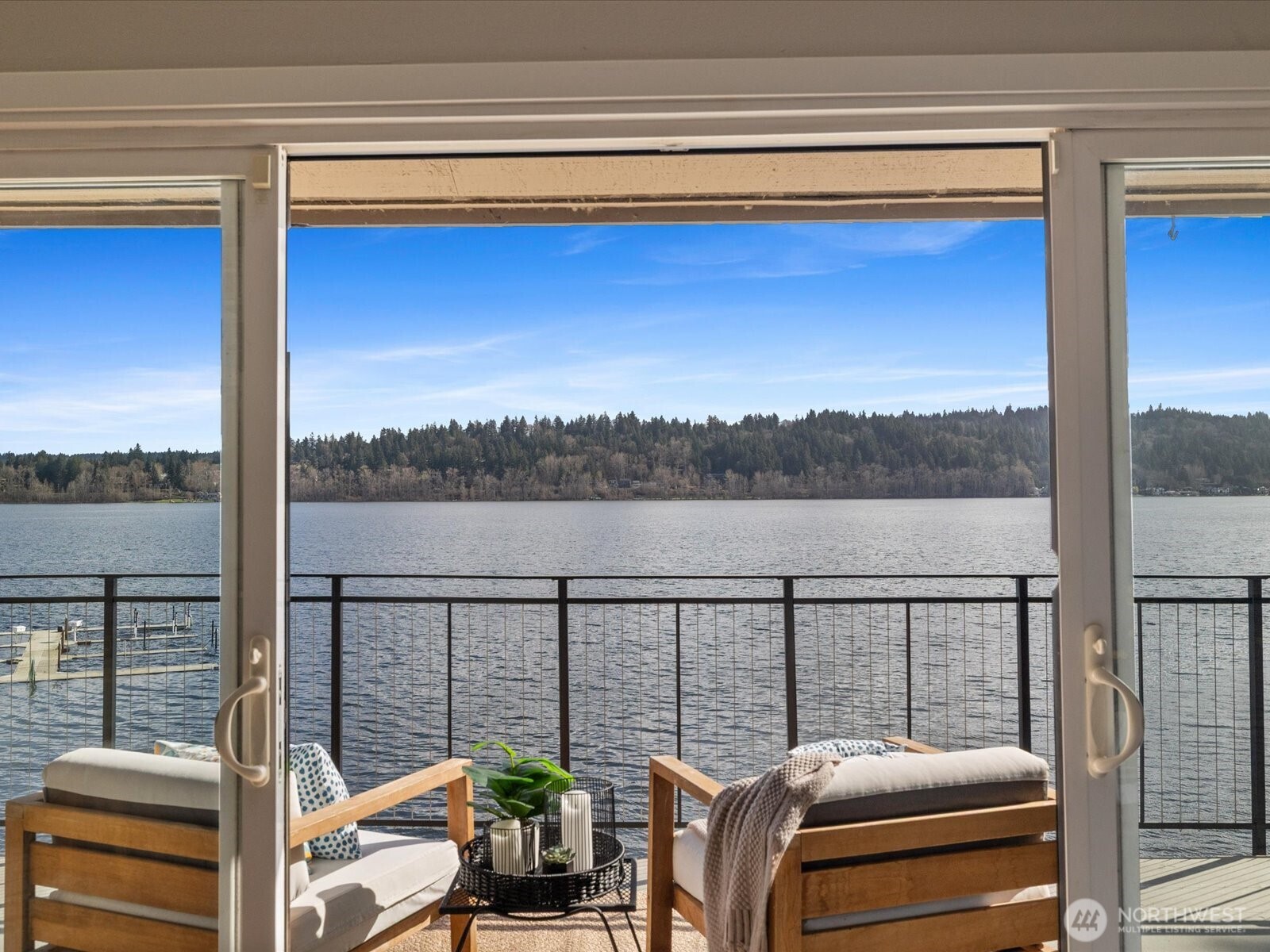 Lake Sammamish view from interior through sliding glass doors with access to private waterfront deck
