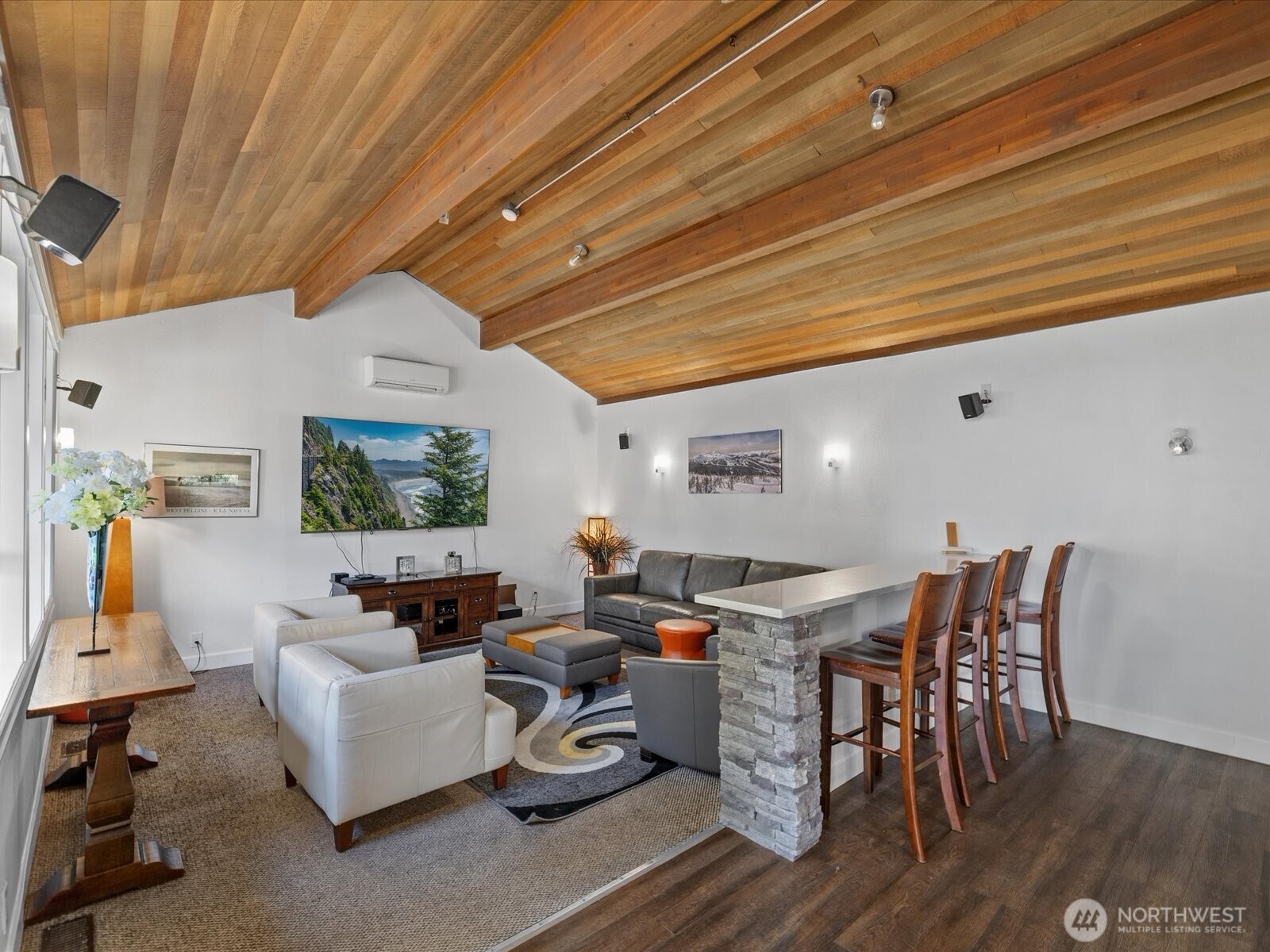 Community clubhouse interior with wood ceiling, seating area, and recreation space