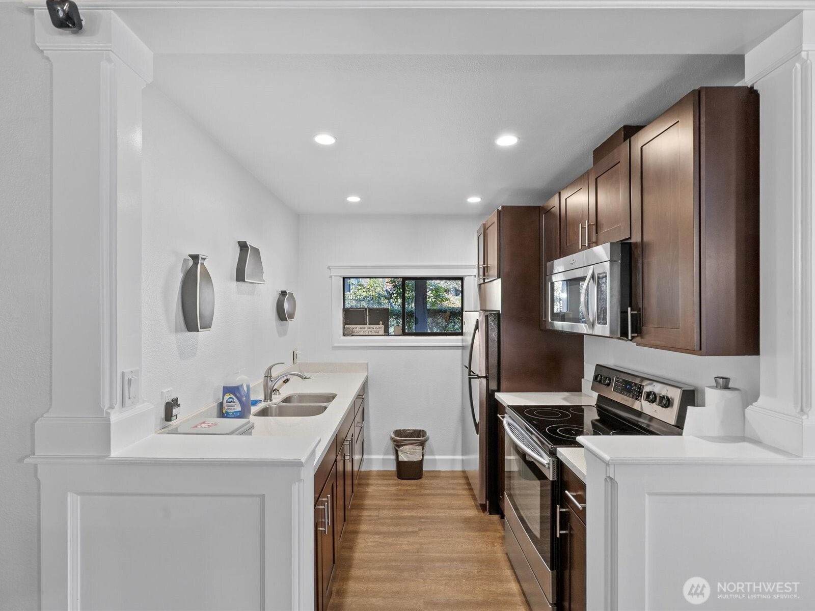 Laundry and utility room with sink, cabinetry, and full-size washer and dryer