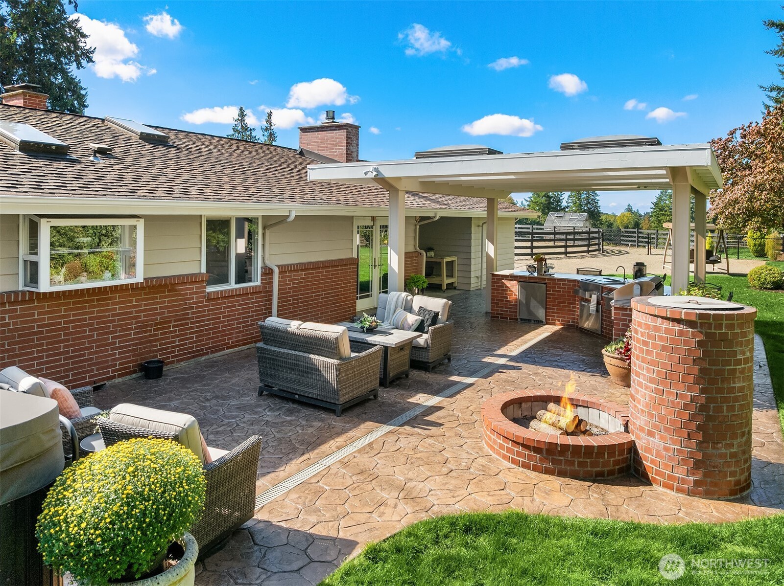 Brick firepit off outdoor kitchen