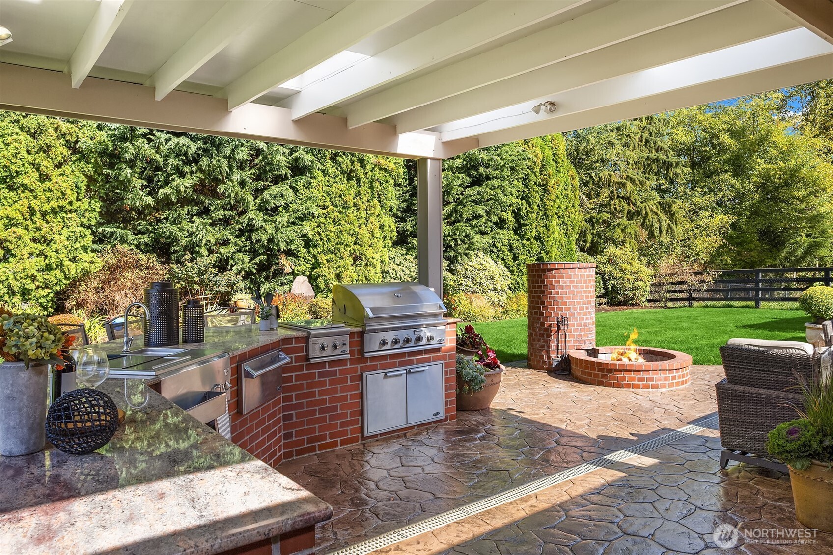 Covered outdoor living with grand scale custom-built outdoor kitchen
