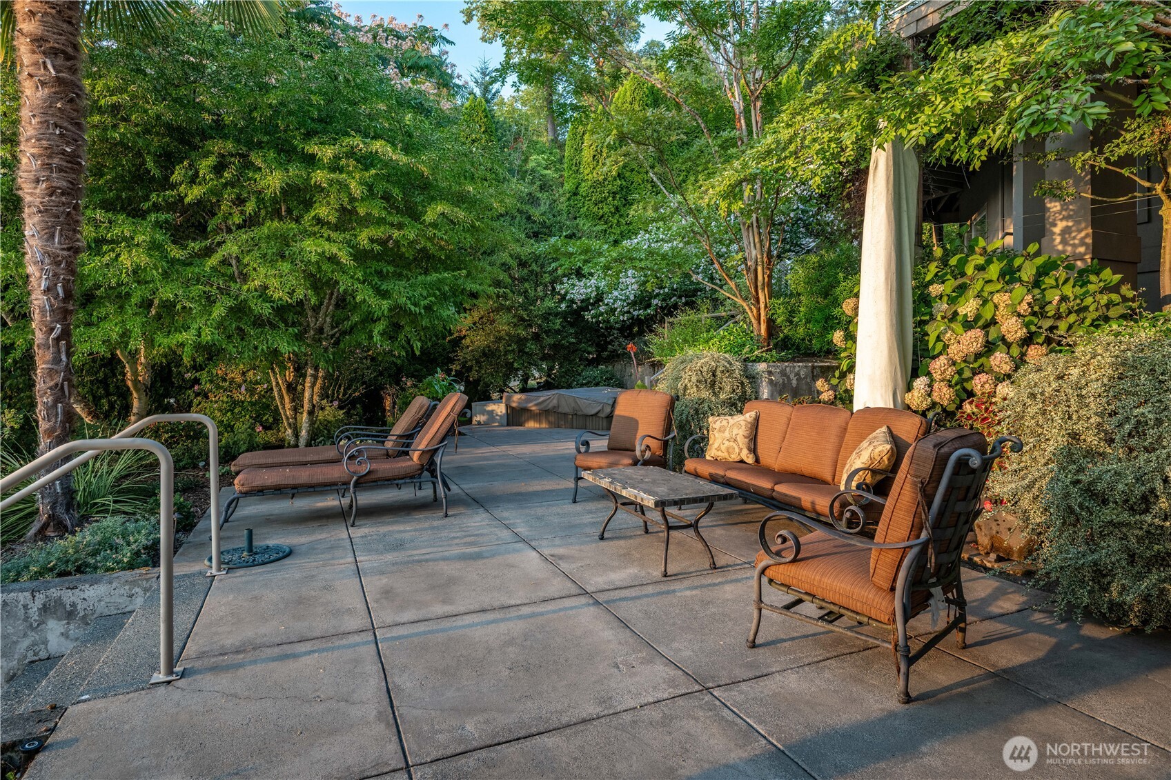 One of several outdoor living spaces, this sun-drenched terrace offers a peaceful and private setting for the hot tub and lounging.
