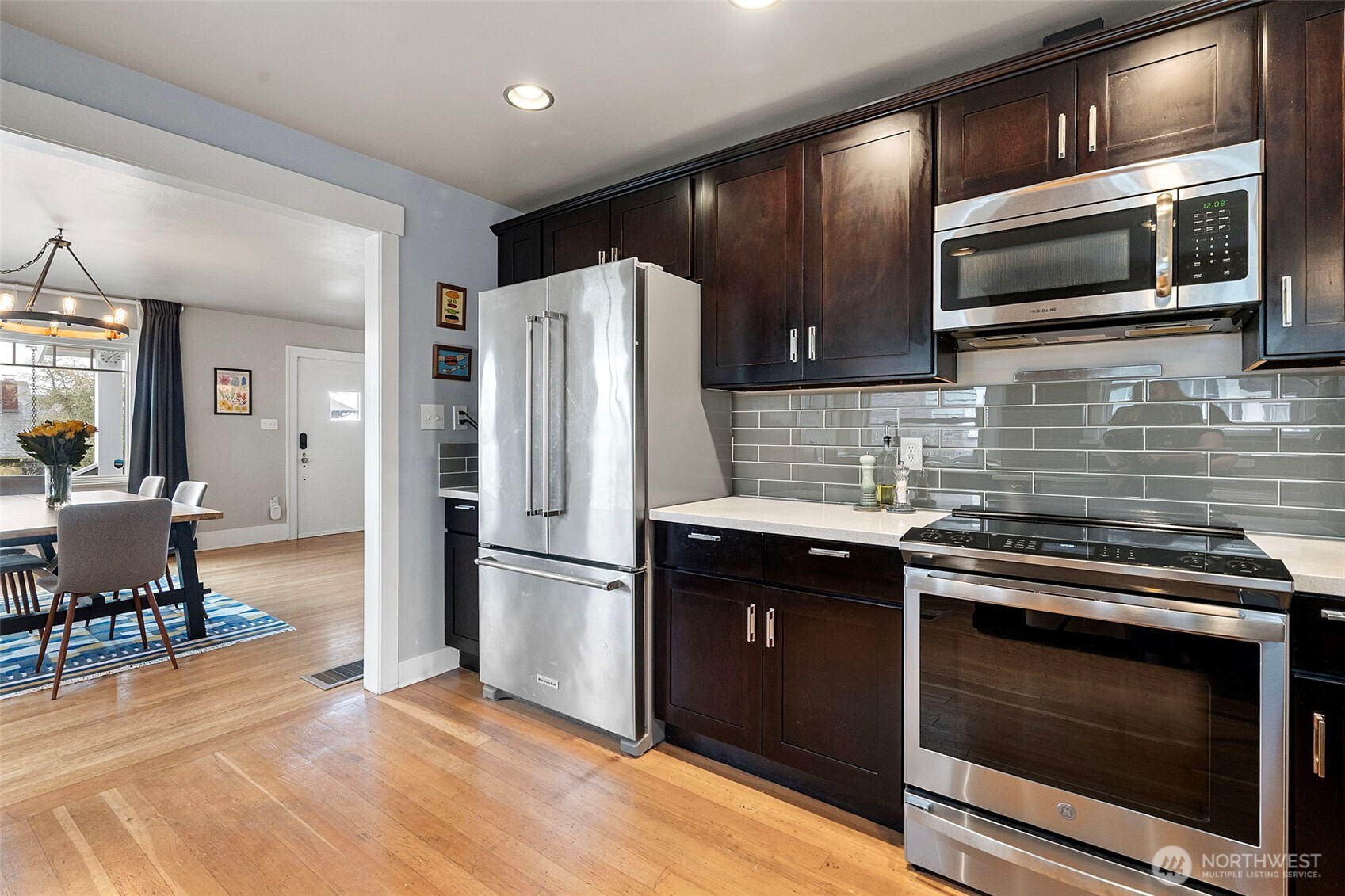 Updated kitchen with quartz countertops, custom cabinets, stainless appliances.