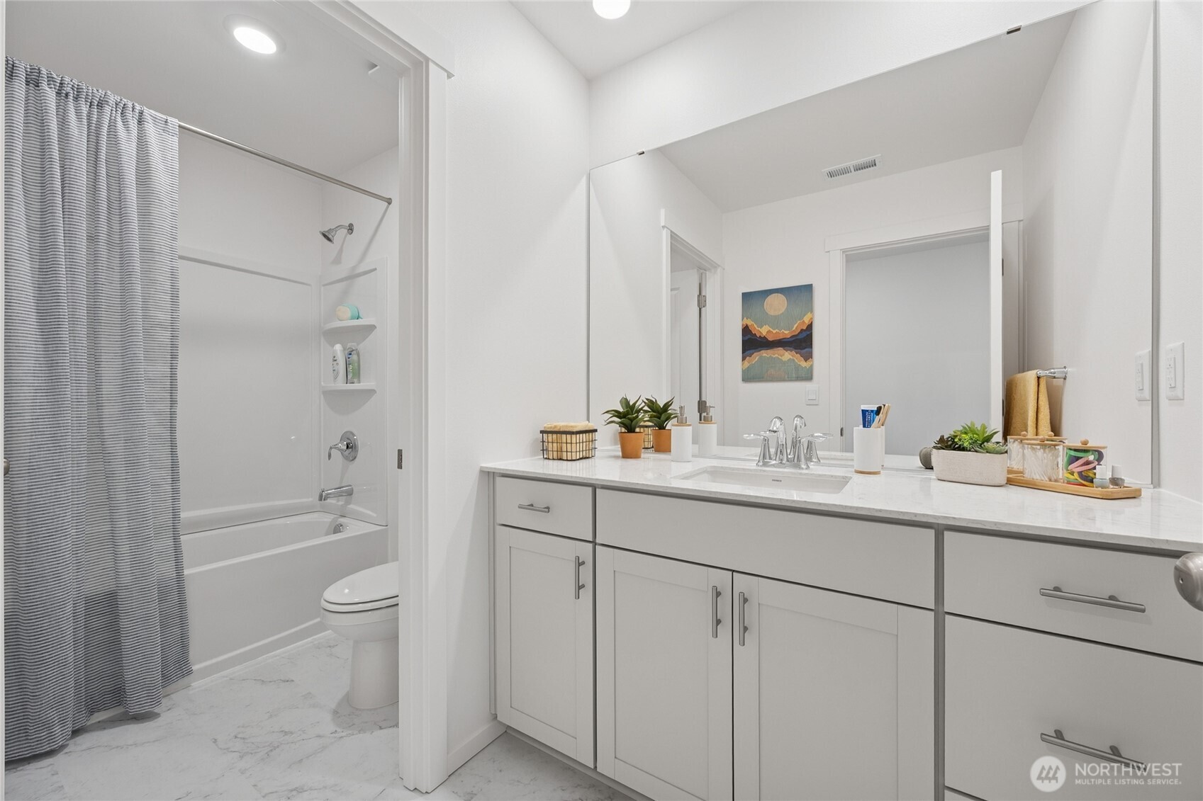 Secondary bathroom upstairs with a door separating the shower/toilet area from the sink w/ quartz countertops and soft close cabinets.  Pictures are for representational purposes only, colors and features may vary.