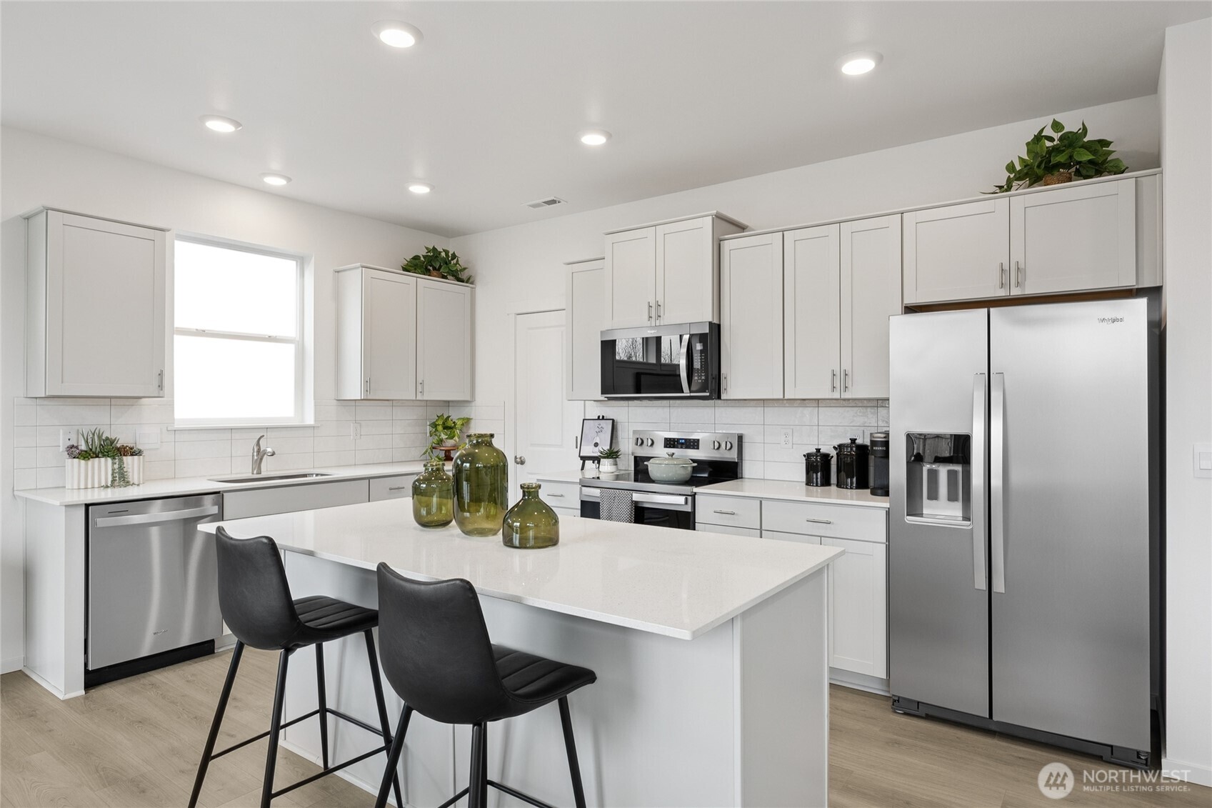 Kitchen with quartz countertops, full height backsplash, and soft close cabinets.  Pictures are for representational purposes only, colors and features may vary.