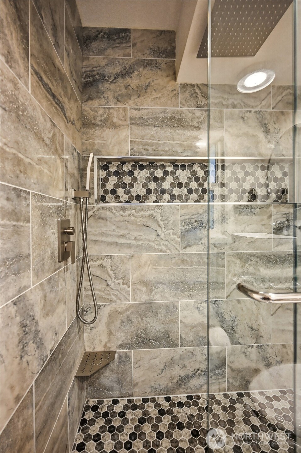 Modern walk-in shower featuring custom tile work and premium rain showerhead.