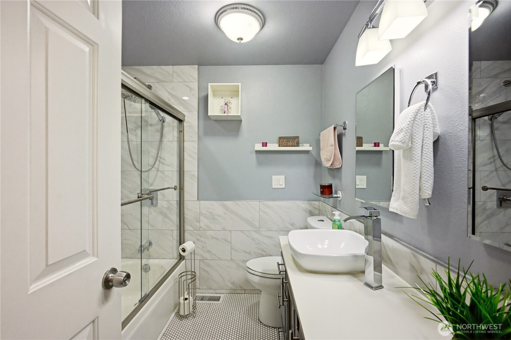 Secondary remodeled full bathroom with modern fixtures.