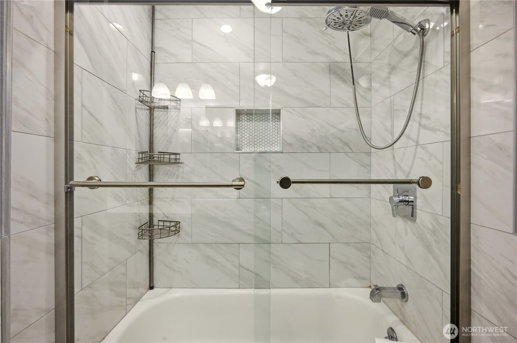 This bathroom features a glass-enclosed shower and an integrated soaking tub.