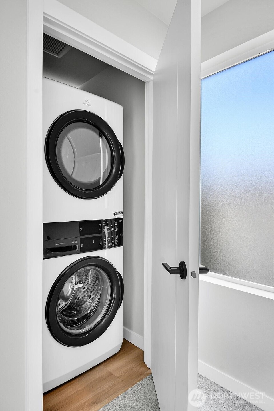Utility closet easily fits a stackable washer & dryer.