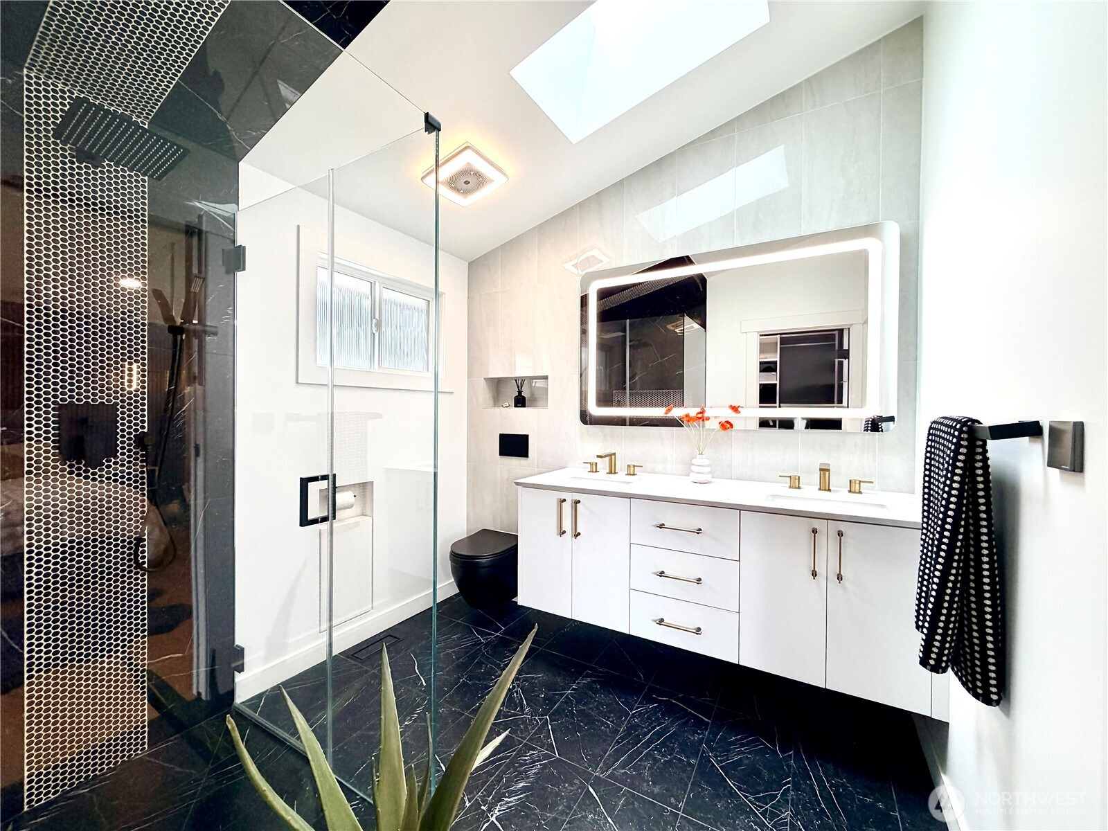 Fully remodeled bathrooms with quartz countertops and frameless glass shower doors