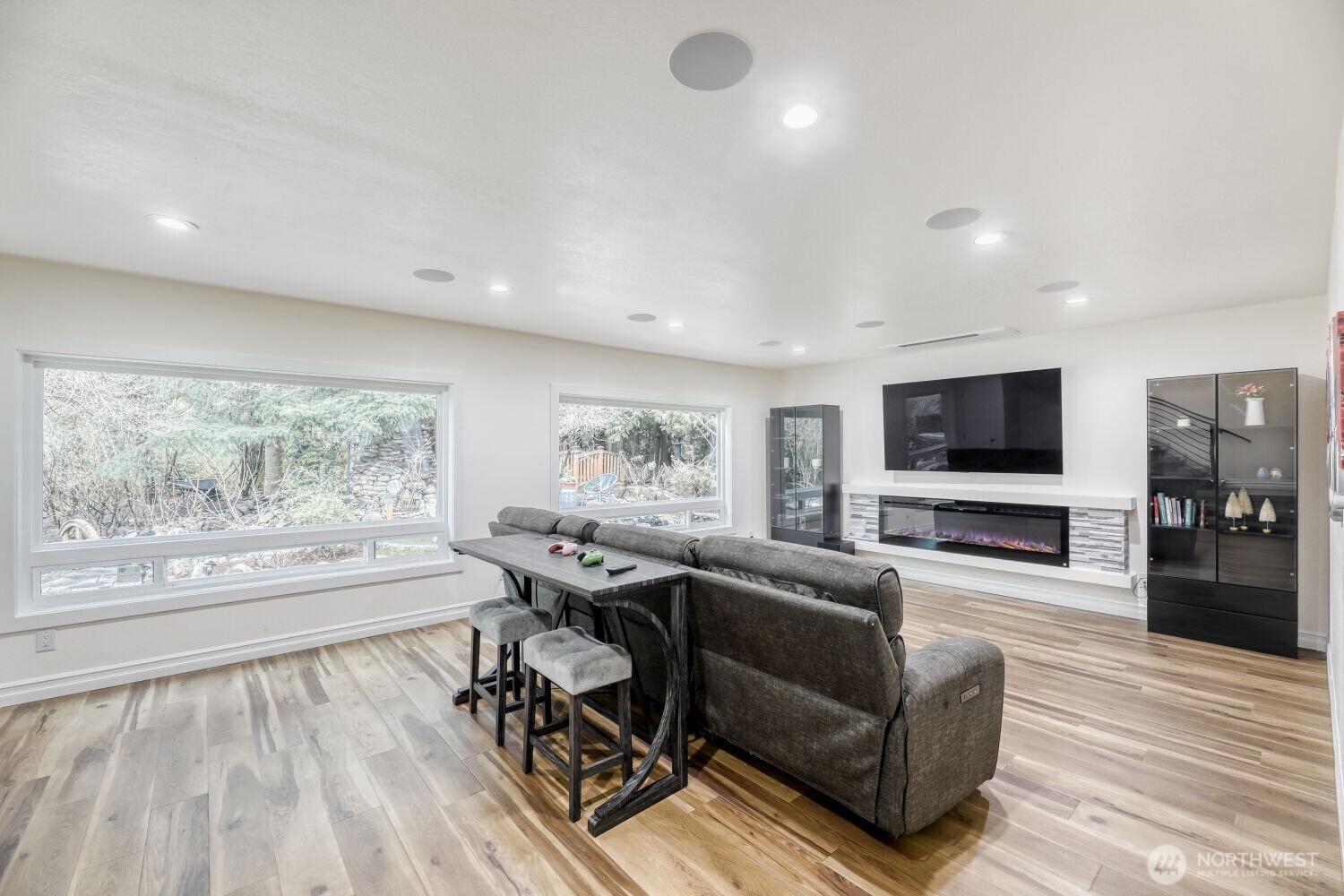 Open media room with electric fireplace puts out the heat or just the visual effect.