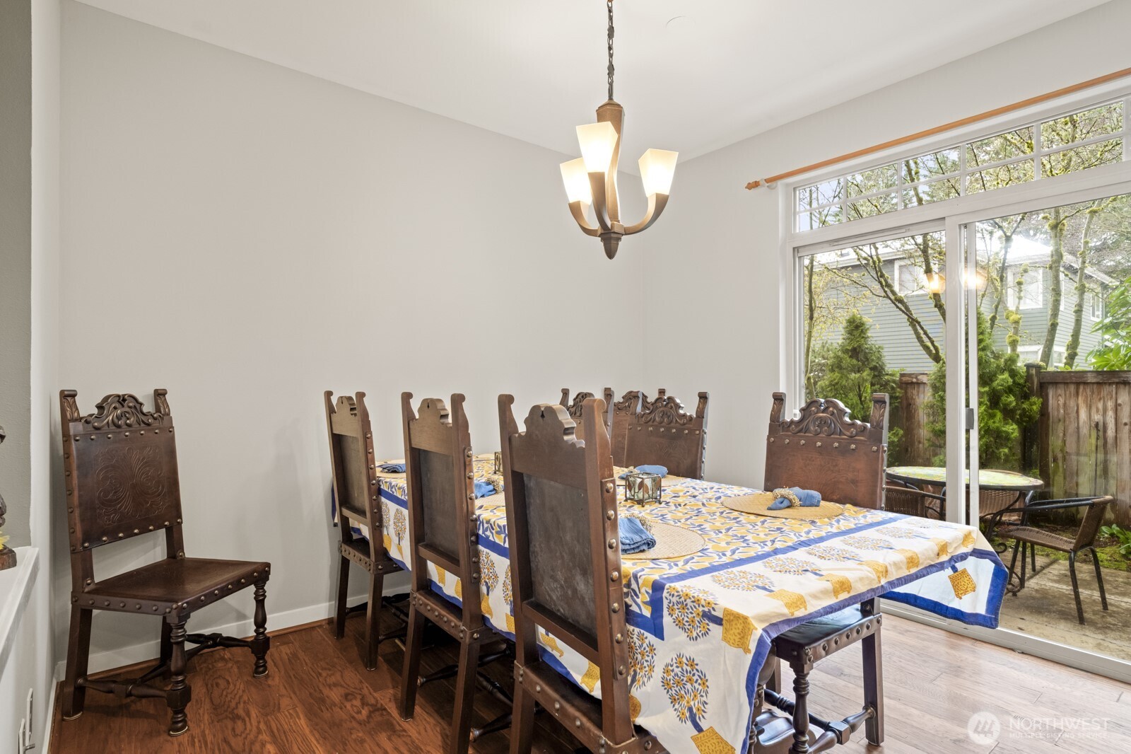 The spacious dining area features a sliding door to the backyard patio and the guest powder bath is updated with a vessel sink and tile floor.