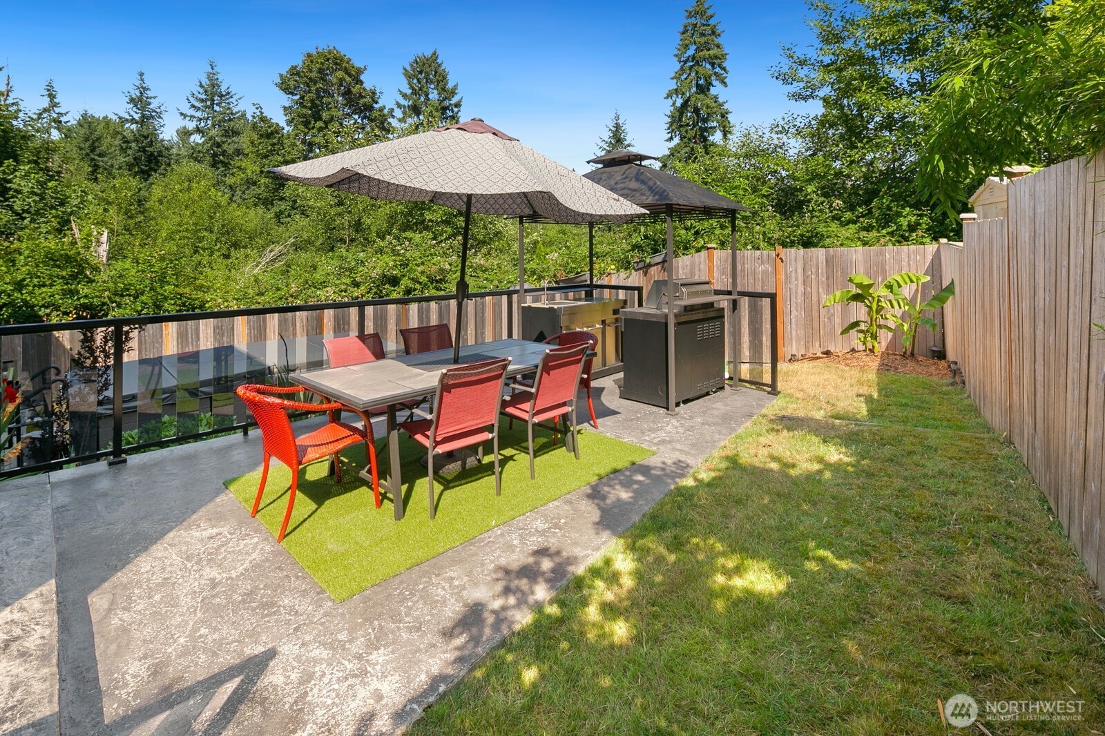Expansive back yard w/ outdoor kitchen, multiple entertaining areas, Swim Spa & garden beds