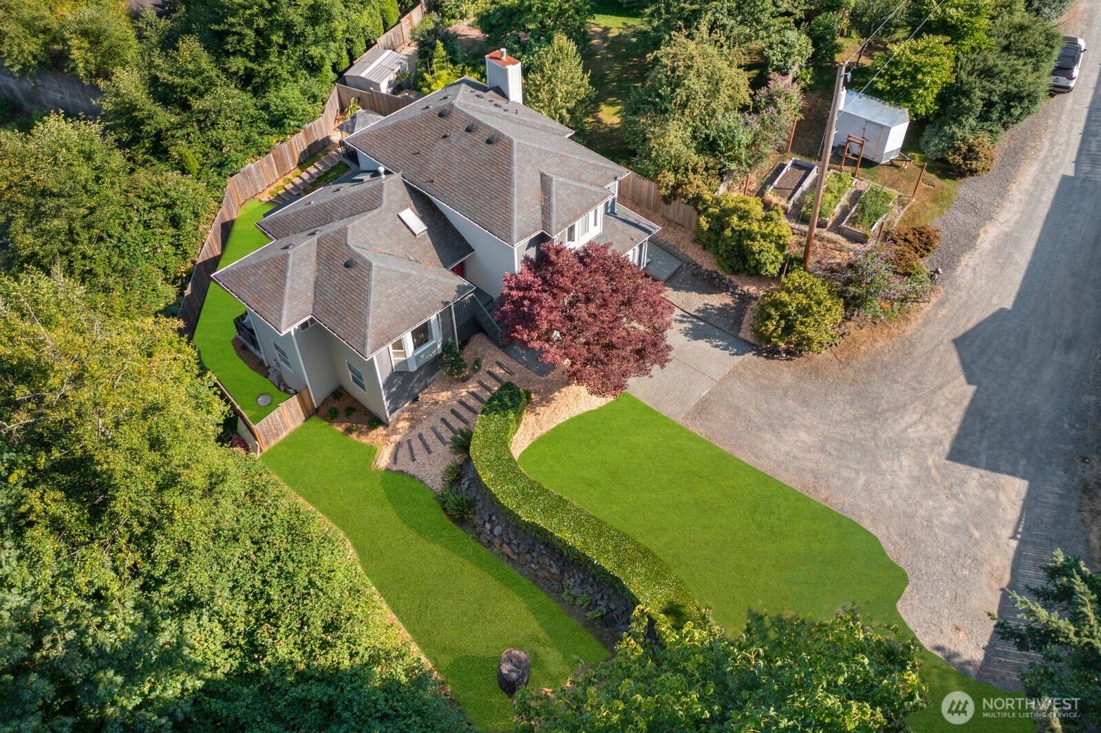 Expansive back yard w/ outdoor kitchen, multiple entertaining areas, Swim Spa & garden beds