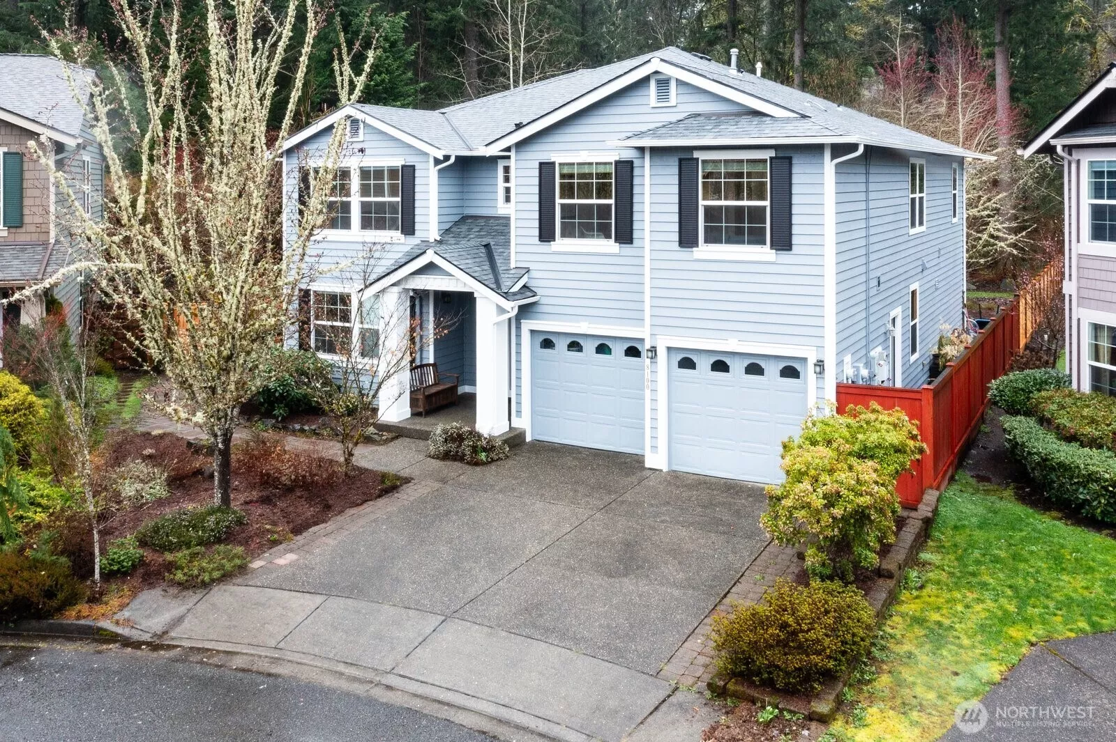 Traditional exterior with window shutters, covered front porch and manicured flowerbeds create an impressive first impression