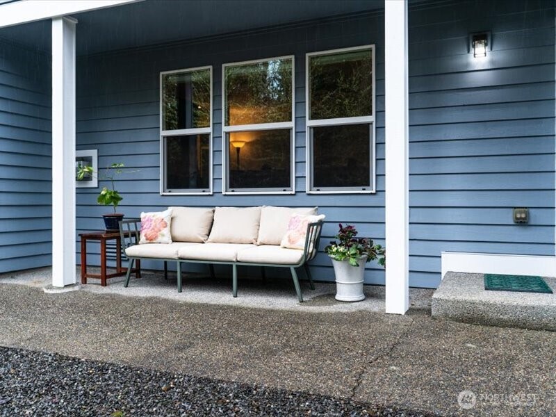 A place to relax on this covered back porch ideal for observing nature enjoying the outdoors, even on a rainy day