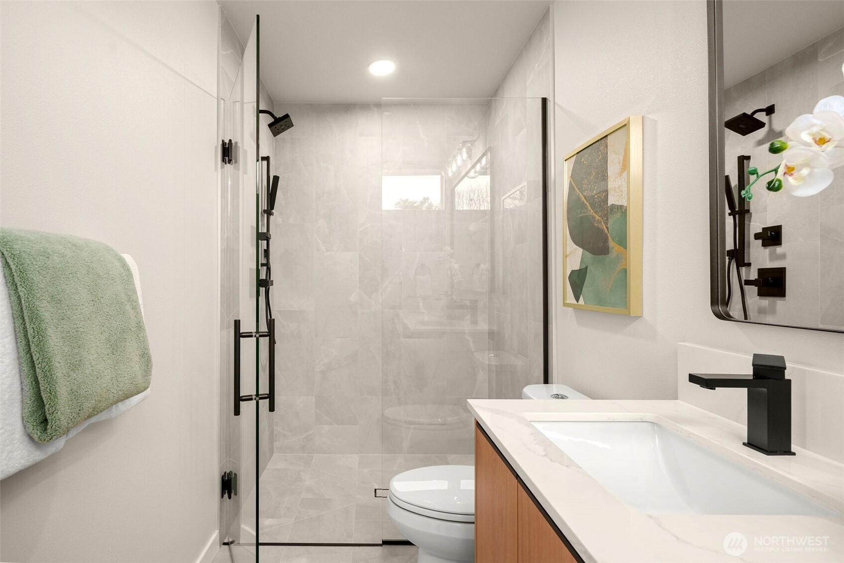 The primary bath includes all the high-end finishes found throughout the home plus a full tile surround shower with two heads