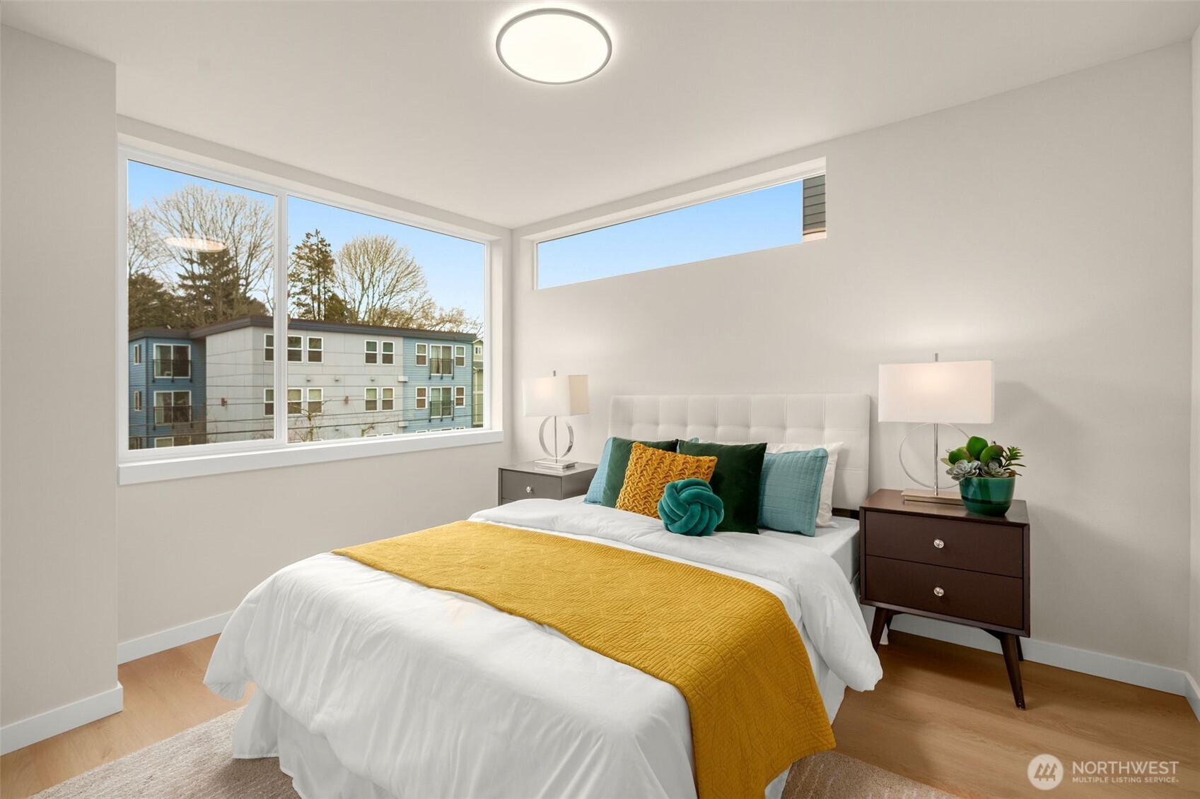 Second bedroom offers an enlarged space with a full bath just outside