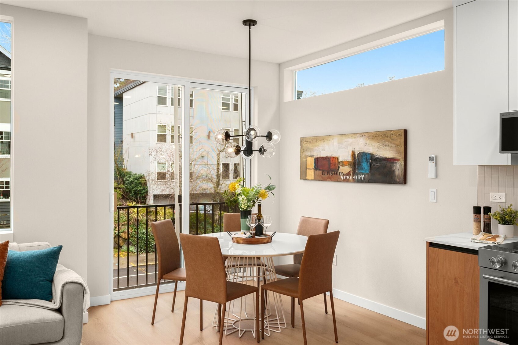 An inviting open-concept main floor features soaring ceilings and expansive windows that flood the space with natural light