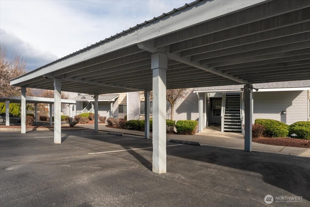 Covered carport parking space plus another uncovered parking space.