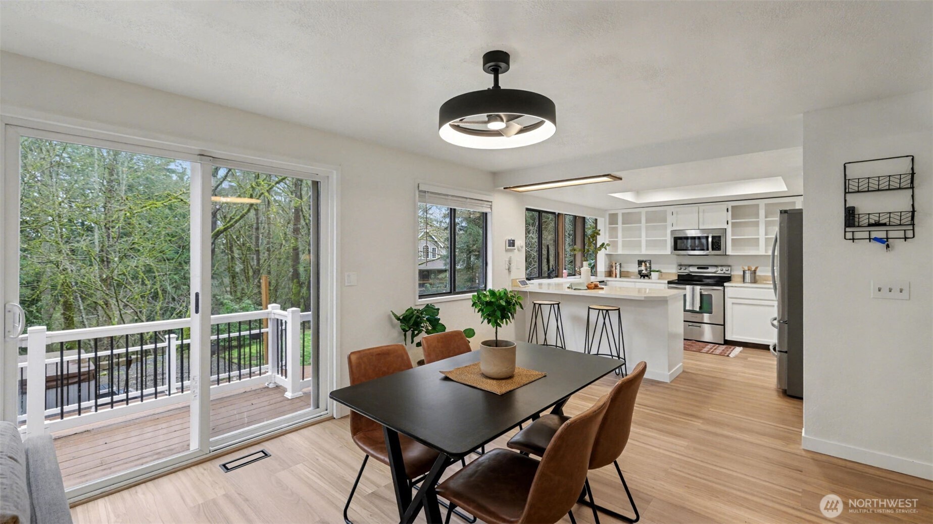 Bright and open, this dining space offers direct access to the deck for seamless indoor outdoor living.
