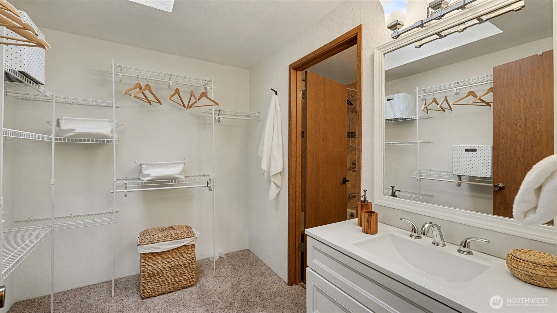 A well-designed walk-in closet offering abundant shelving, hanging space, and a seamless connection to the ensuite.