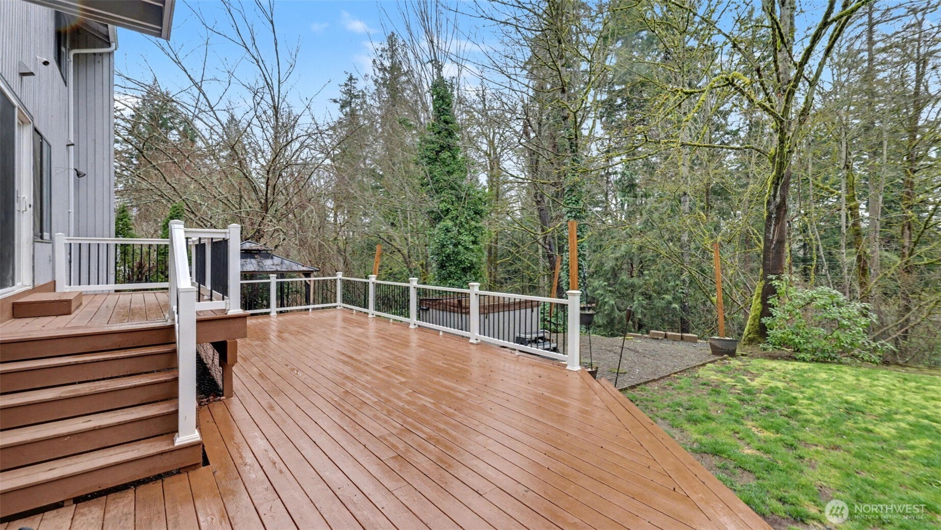 Enjoy expansive outdoor living with a deck that flows effortlessly into the surrounding yard.