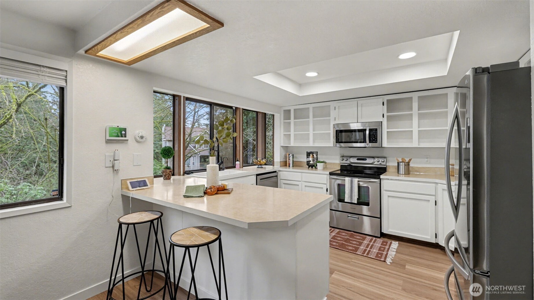 A bright and functional kitchen featuring a spacious peninsula with seating—perfect for casual dining or morning coffee.