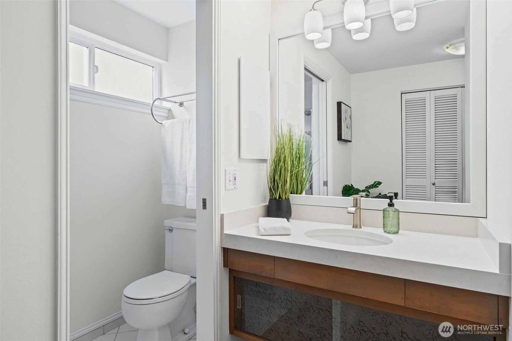 The Primary ensuite bath with a sleek vanity, quartz countertop, and modern fixtures. A dedicated shower and clean finishes create a streamlined space for daily routines.