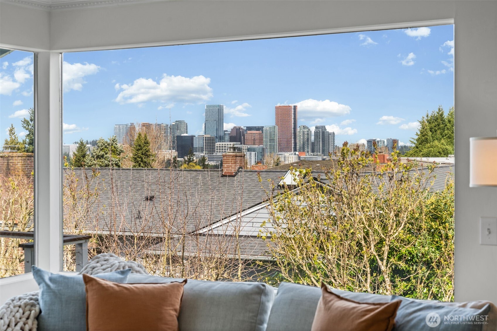 Expansive picture window frames stunning city skyline views, bringing natural light and an ever-changing urban backdrop into your living space. A rare blend of privacy and scenery creates a truly elevated everyday living experience.