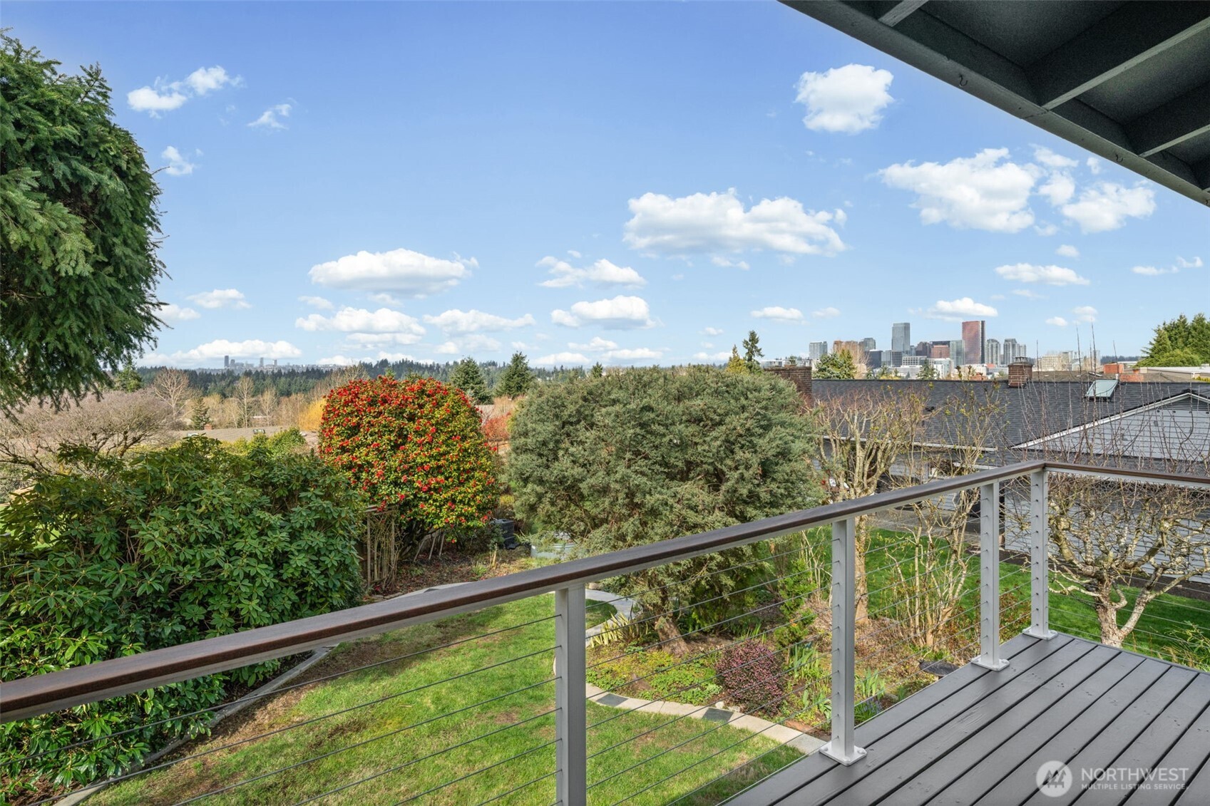Elevated deck showcasing sweeping territorial views with stunning vistas of the Bellevue skyline, Seattle, and the Olympic Mountains—perfect for relaxing or entertaining while taking in the scenery.