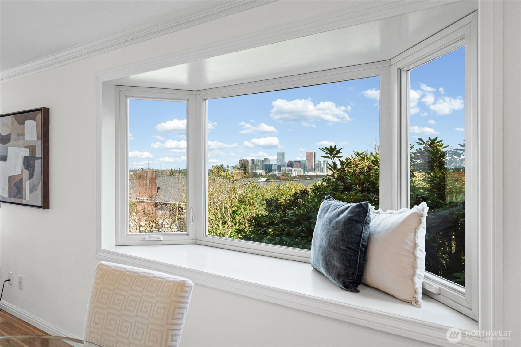 Framed by a stunning bay window, take in sweeping views of the Bellevue skyline from the comfort of your own home. Crisp white millwork, crown molding, and a spacious window seat create the perfect spot to relax and enjoy the scenery.