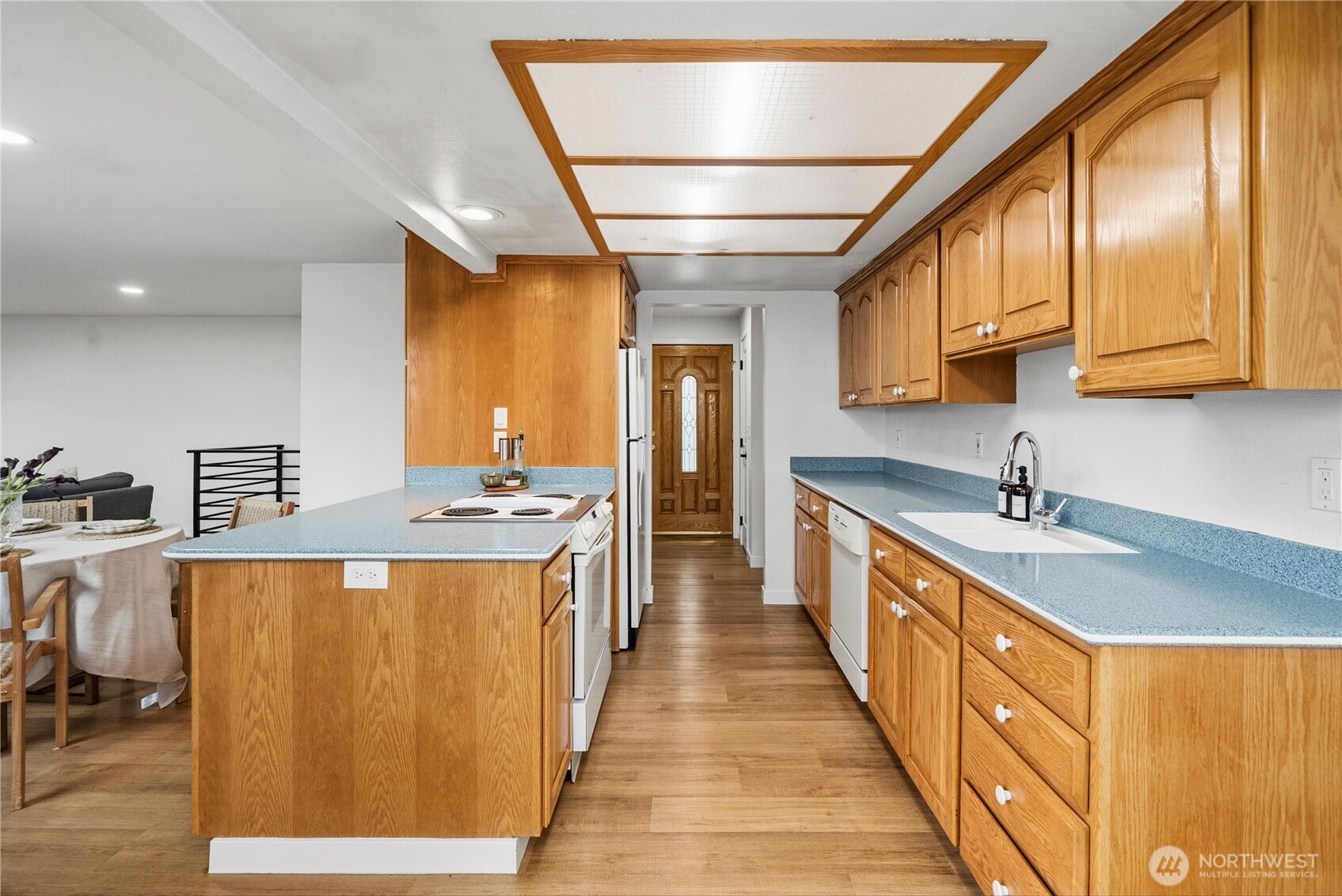 Kitchen with breakfast nook and wide vinyl plank flooring