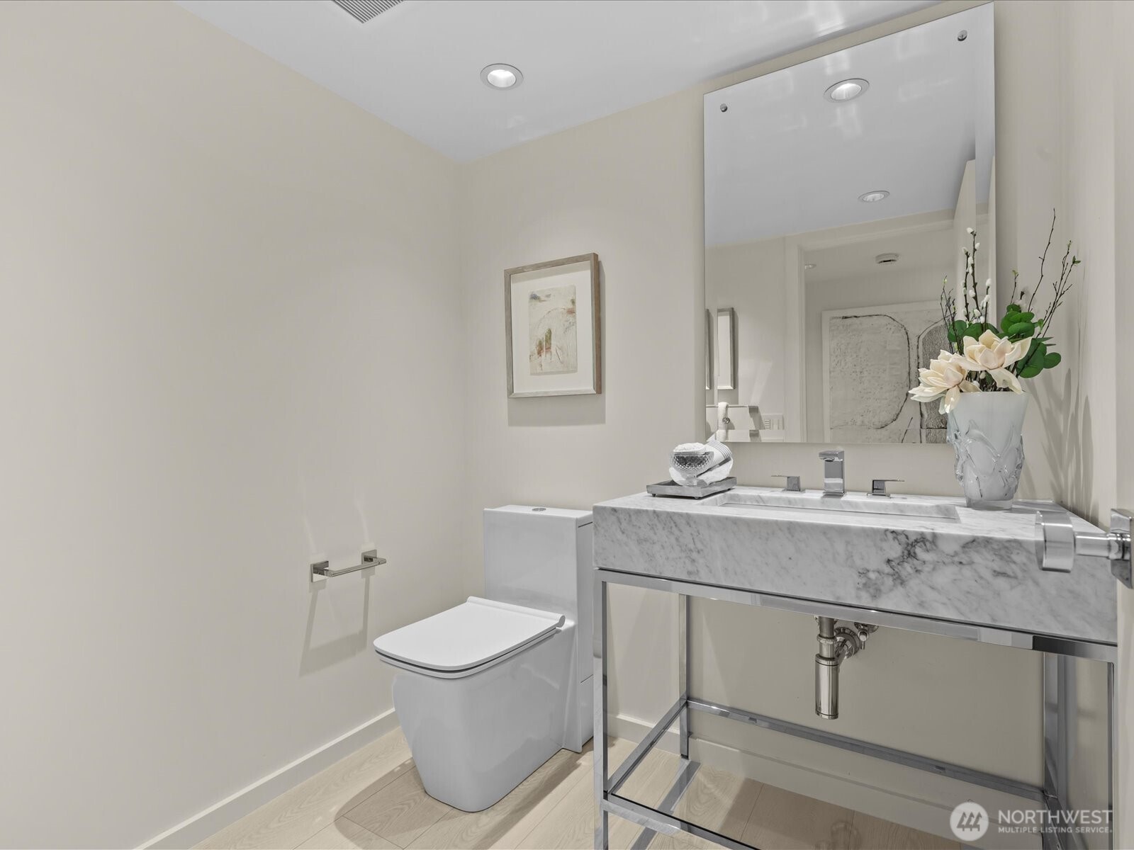 A chic and sophisticated powder room with high-end finishes for guests.