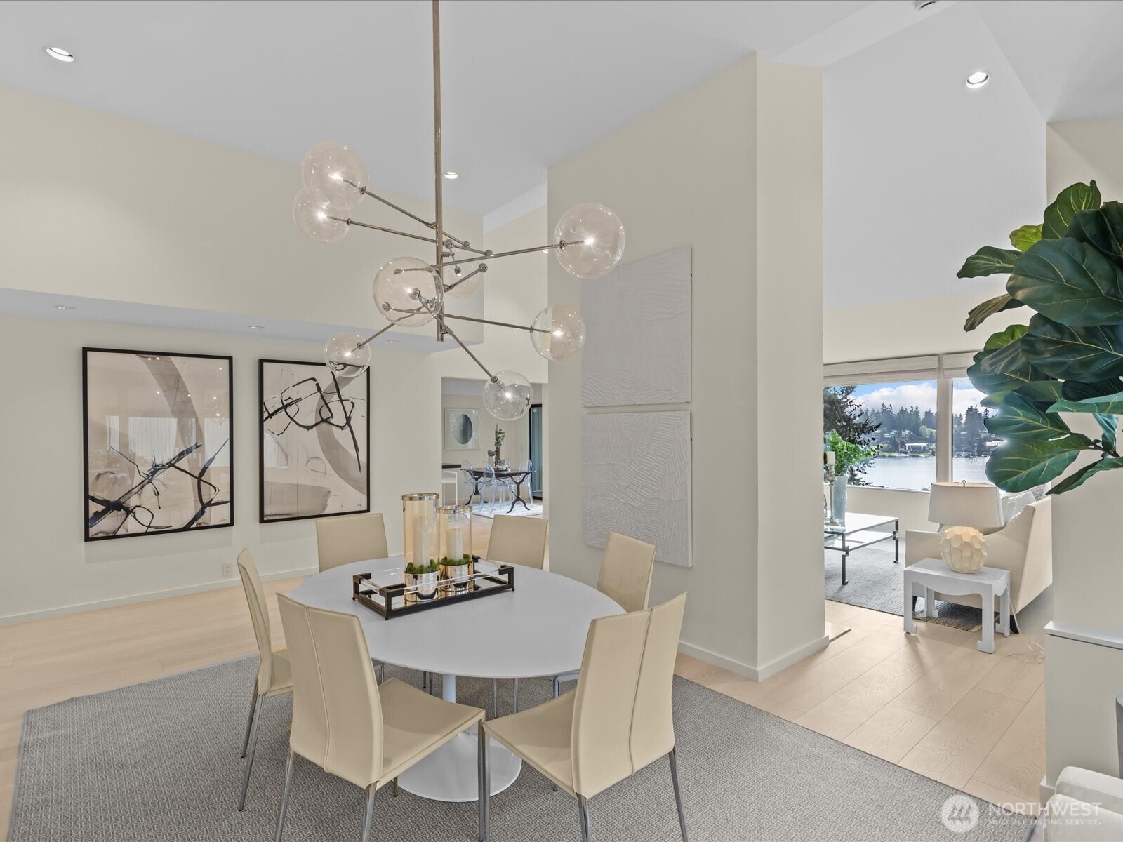 Seamless open-concept living flooded with natural light, featuring views of Lake Washington