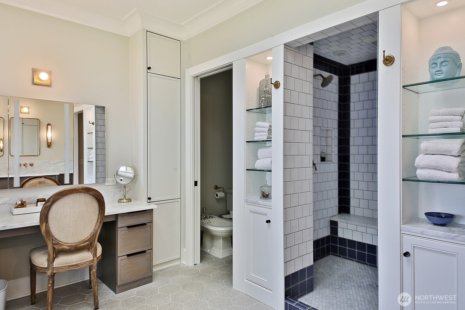 Walk-in shower and dressing table in the primary bath.