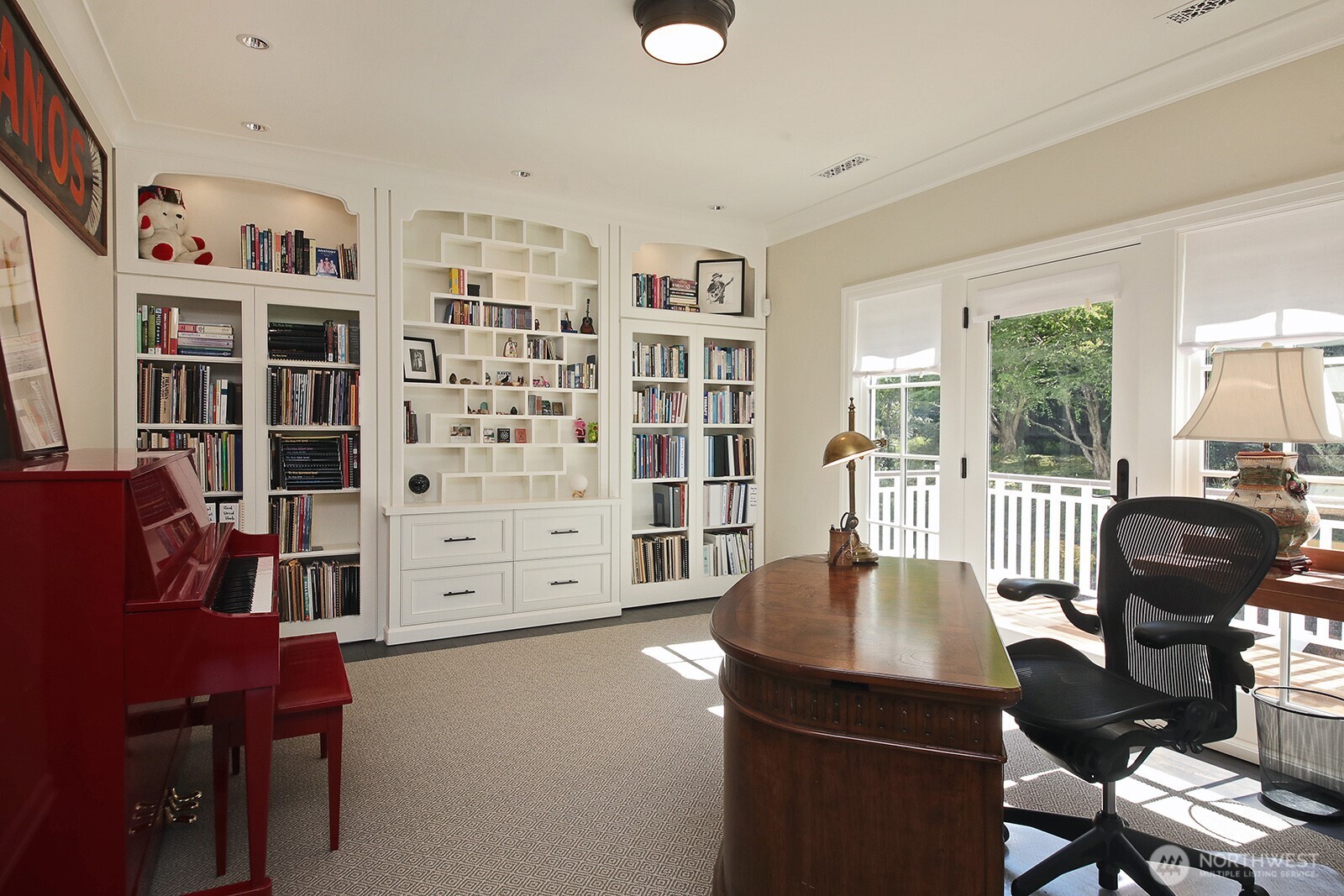 The office/guest quarters continue with a wall of bult-ins and private balcony.