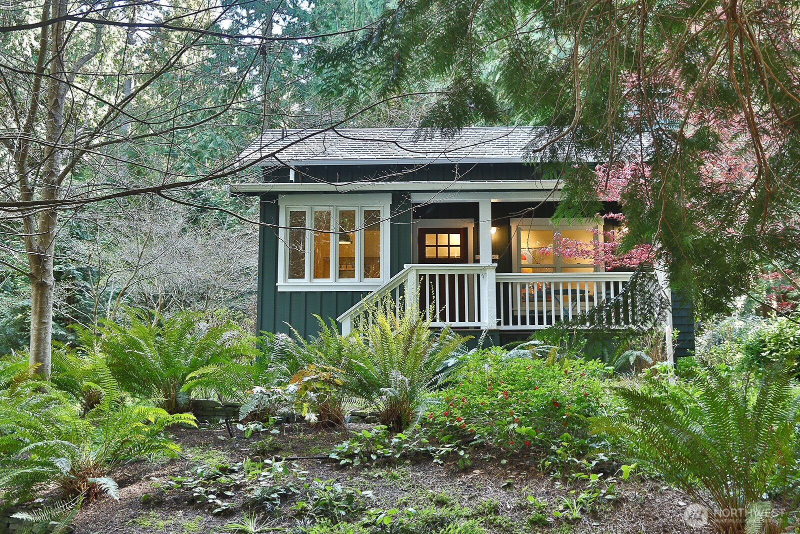 Designed by Ross Chapin, the guest cottage includes one bedroom, a full bath with soaking tub, and two covered porches.