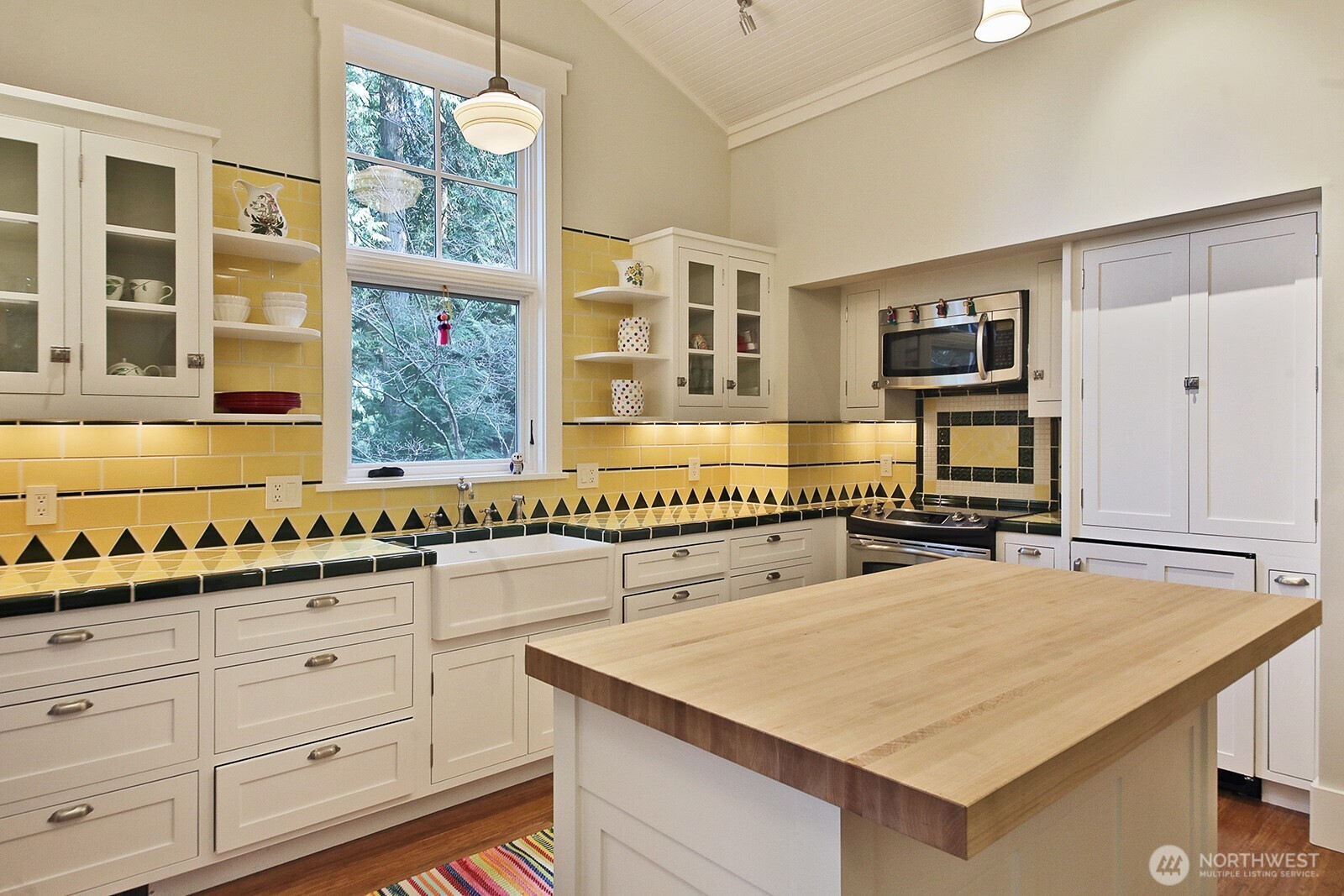 The whimsical kitchen in the guest cottage. Built-in seating is to the left of the photo.