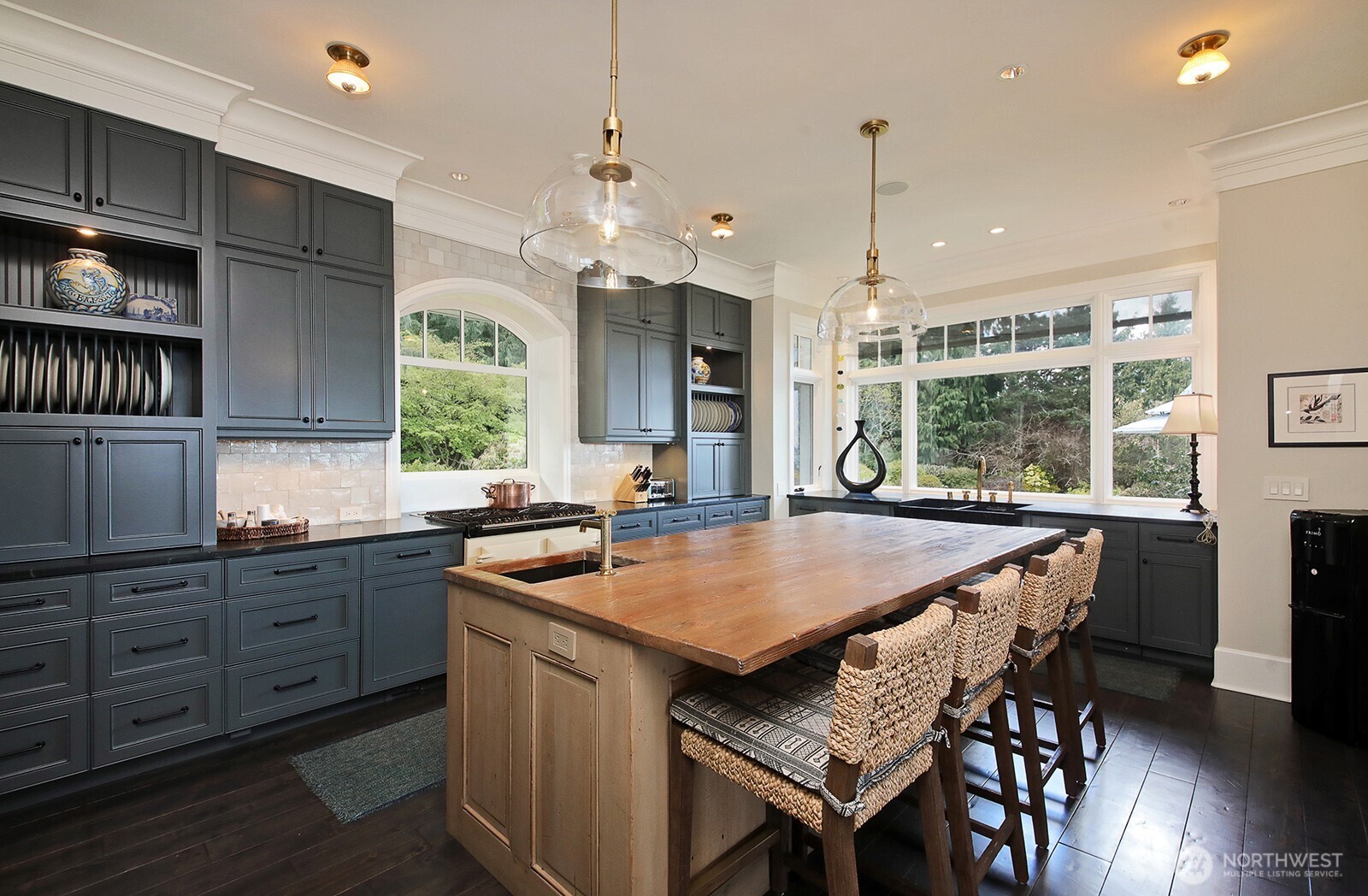 A large wood island and beautiful cabinetry ground the space.