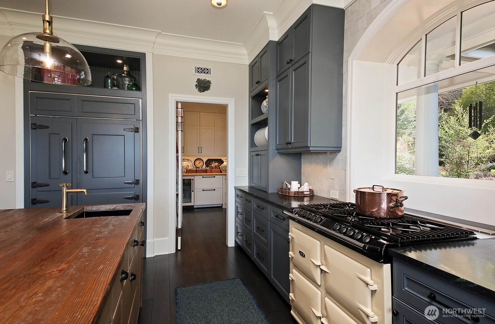 Look at the fantastic Aga oven and paneled refrigerator! The door leads to the butler's pantry.