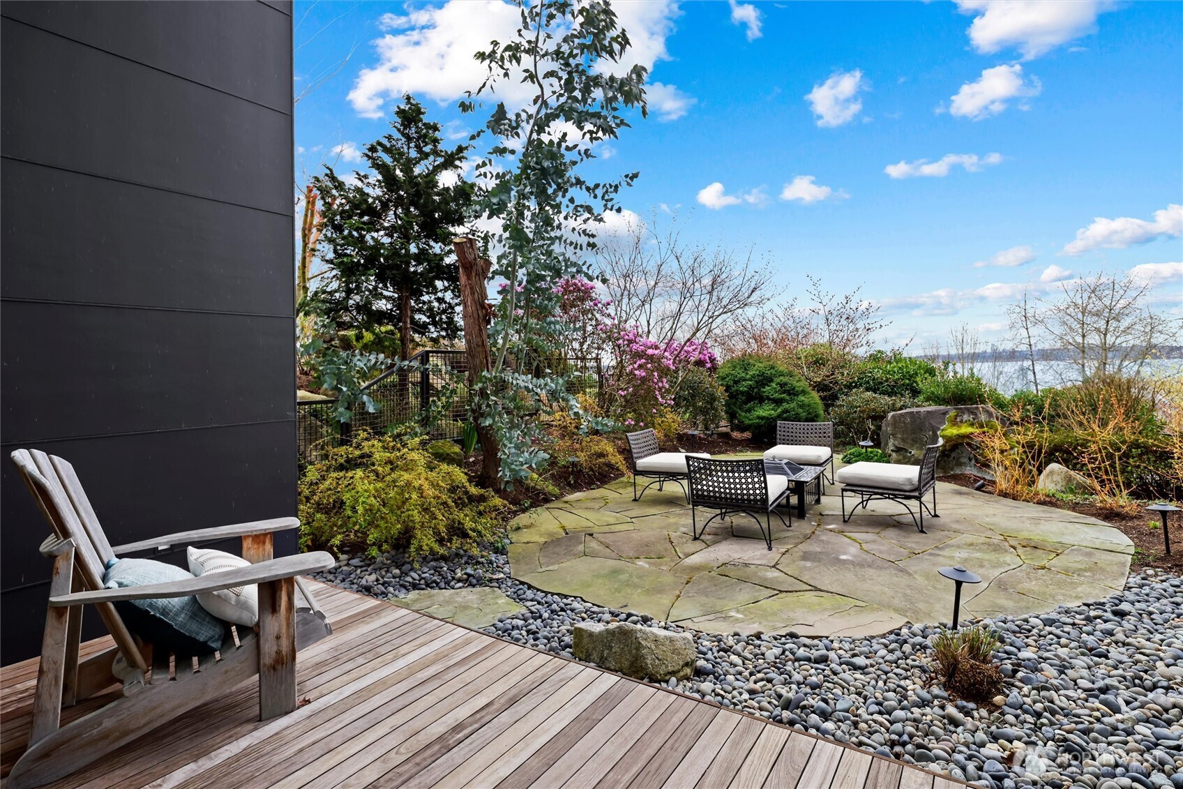 Sculptural landscape boulders, specimen plantings, rock gardens, and an extensive koi pond complete with fountains and a waterfall