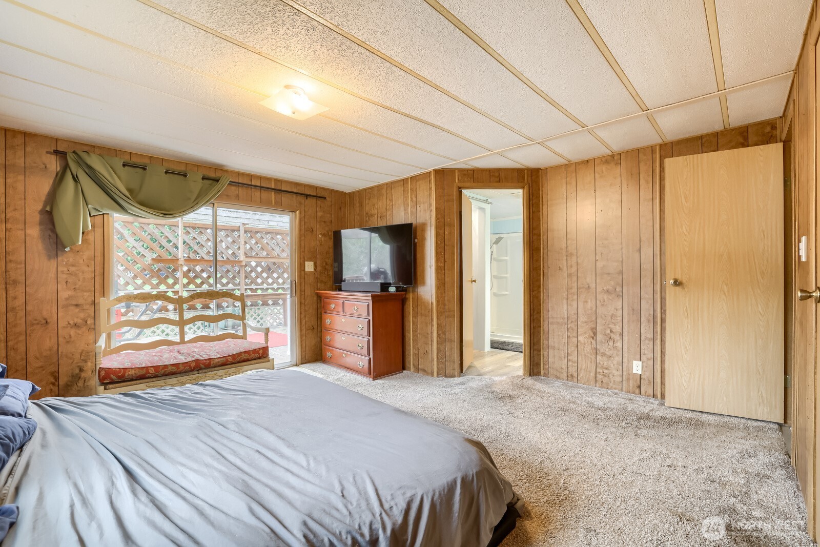 Primary bedroom with a sliding glass door to another covered patio