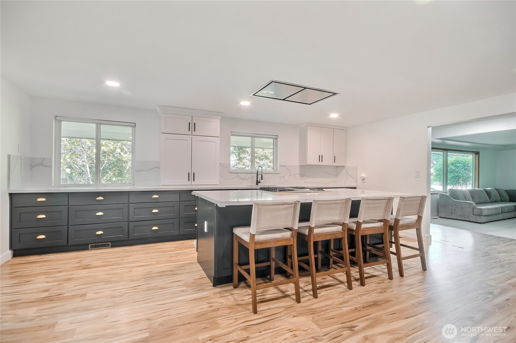 Elegant kitchen with quartz countertops, backsplash and trendy hardware.
